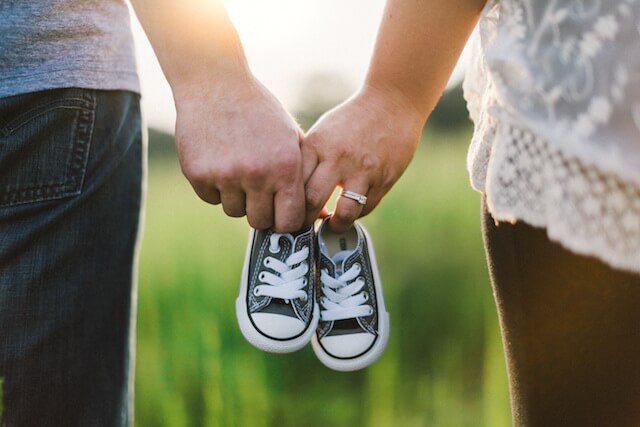 Couple with baby shoes