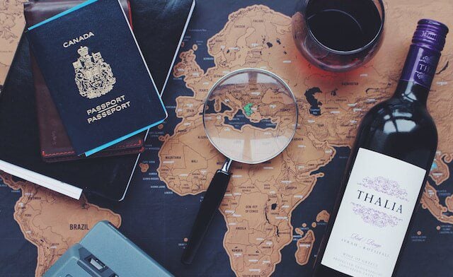 Map with passport and wine