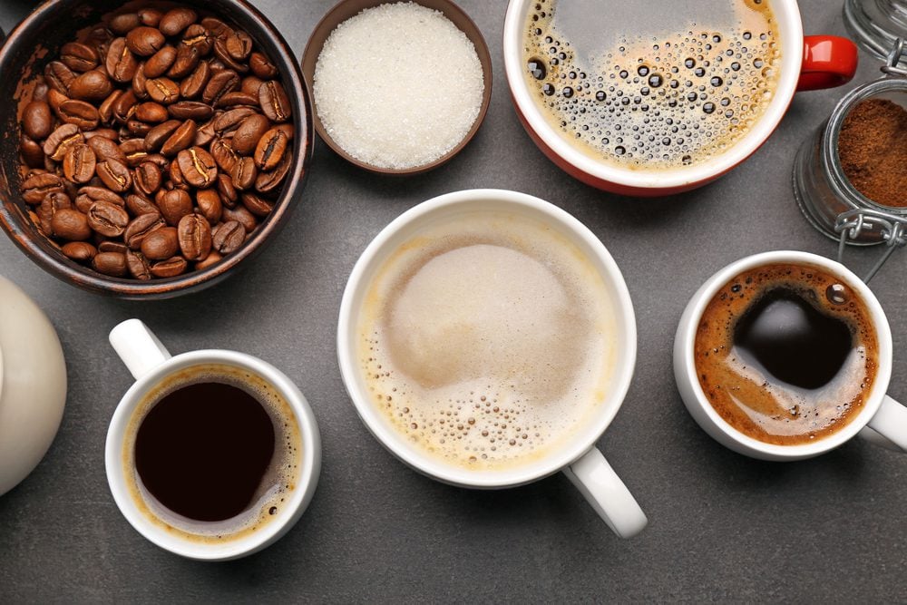 A variety of coffee cups on a dark table