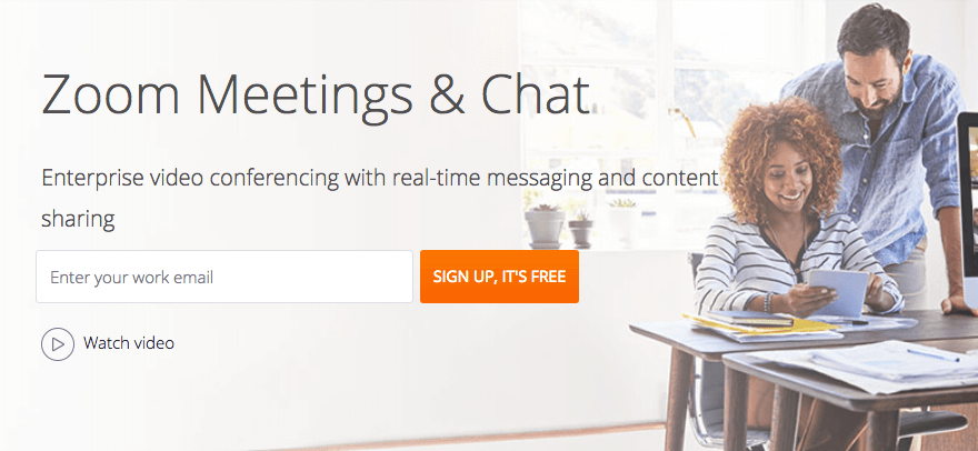 Zoom's website, featuring two people using a tablet.