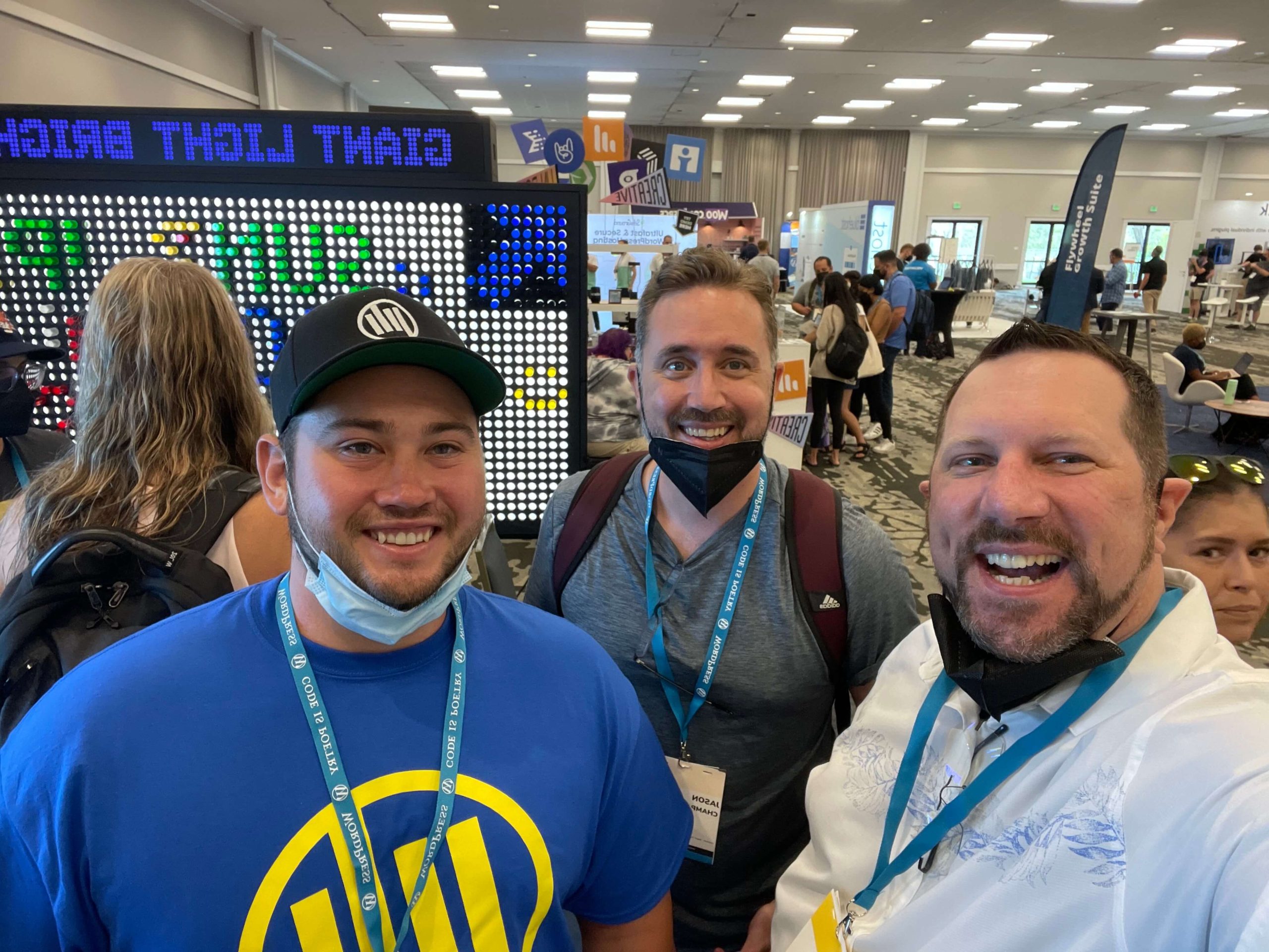 Three men taking an usie in the WCUS Sponsor Hall