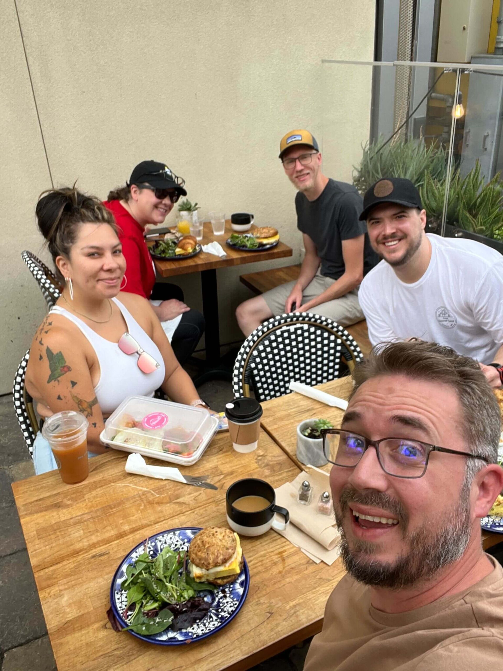 team members having brunch on a restaurant patio