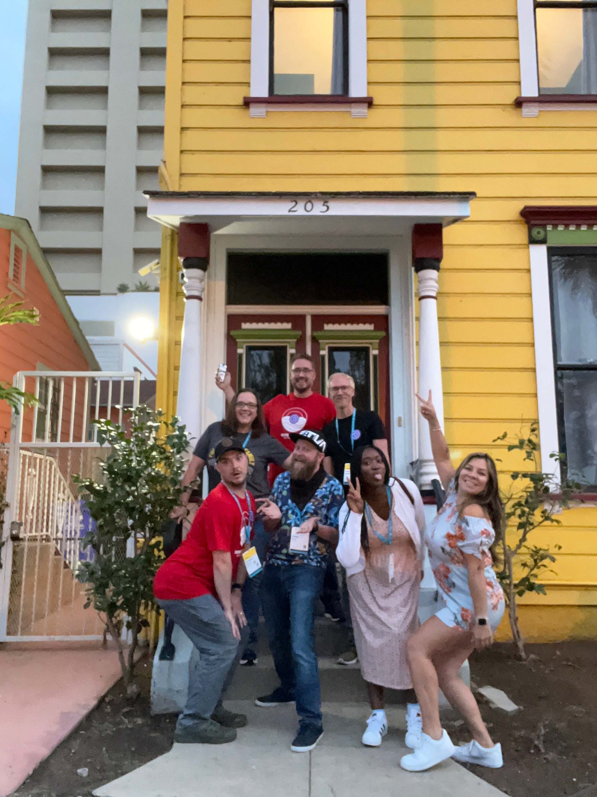 Elegant Themes WCUS Content Team acting silly standing on steps in front of their airbnb