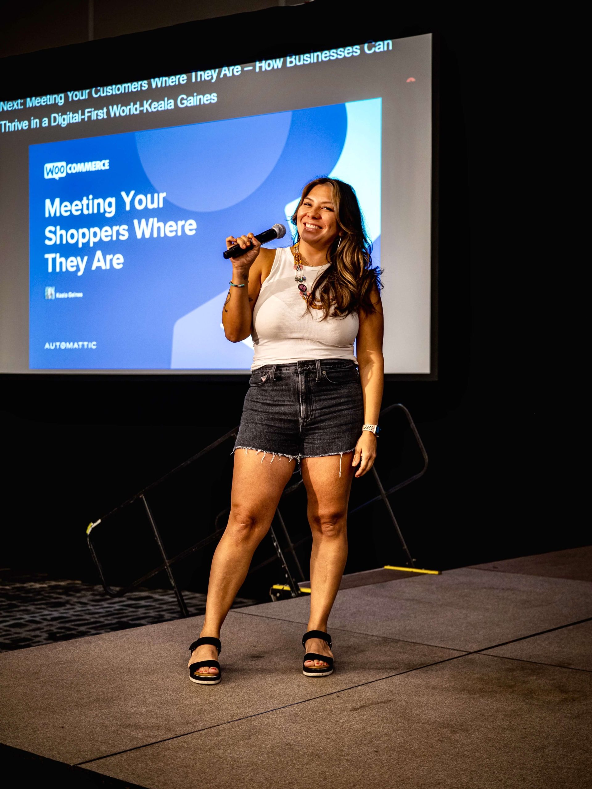 Raquel emcee on stage at WCUS