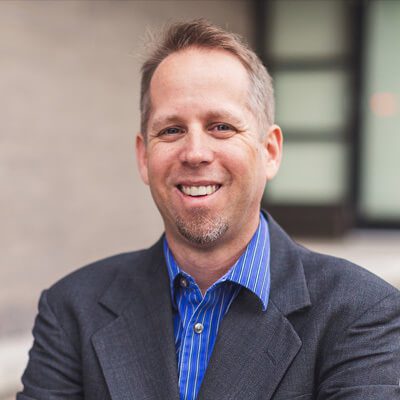 professional headshot of Dennis Dinsmore in suit